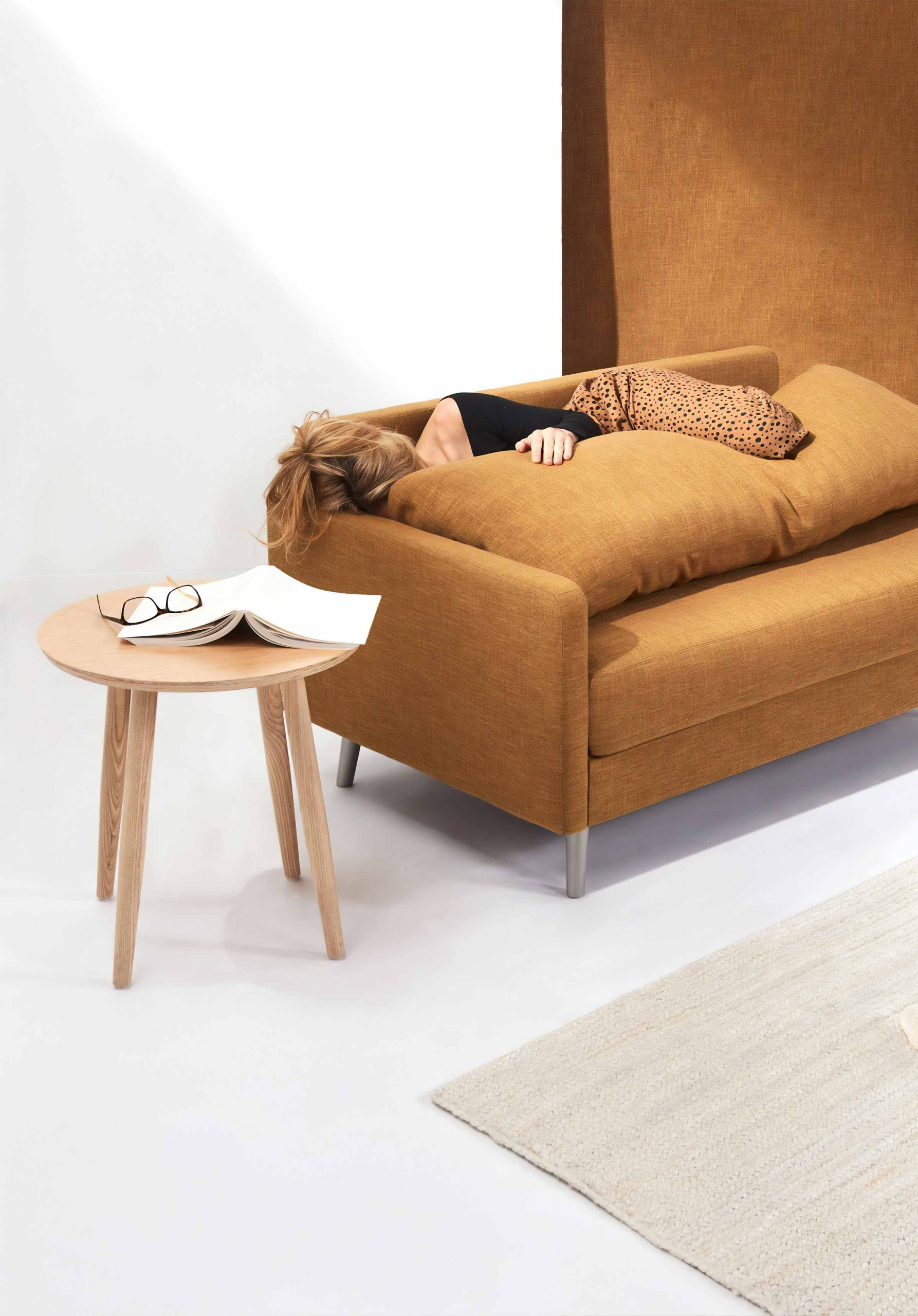 Woman Laying on Brown Sofa 2